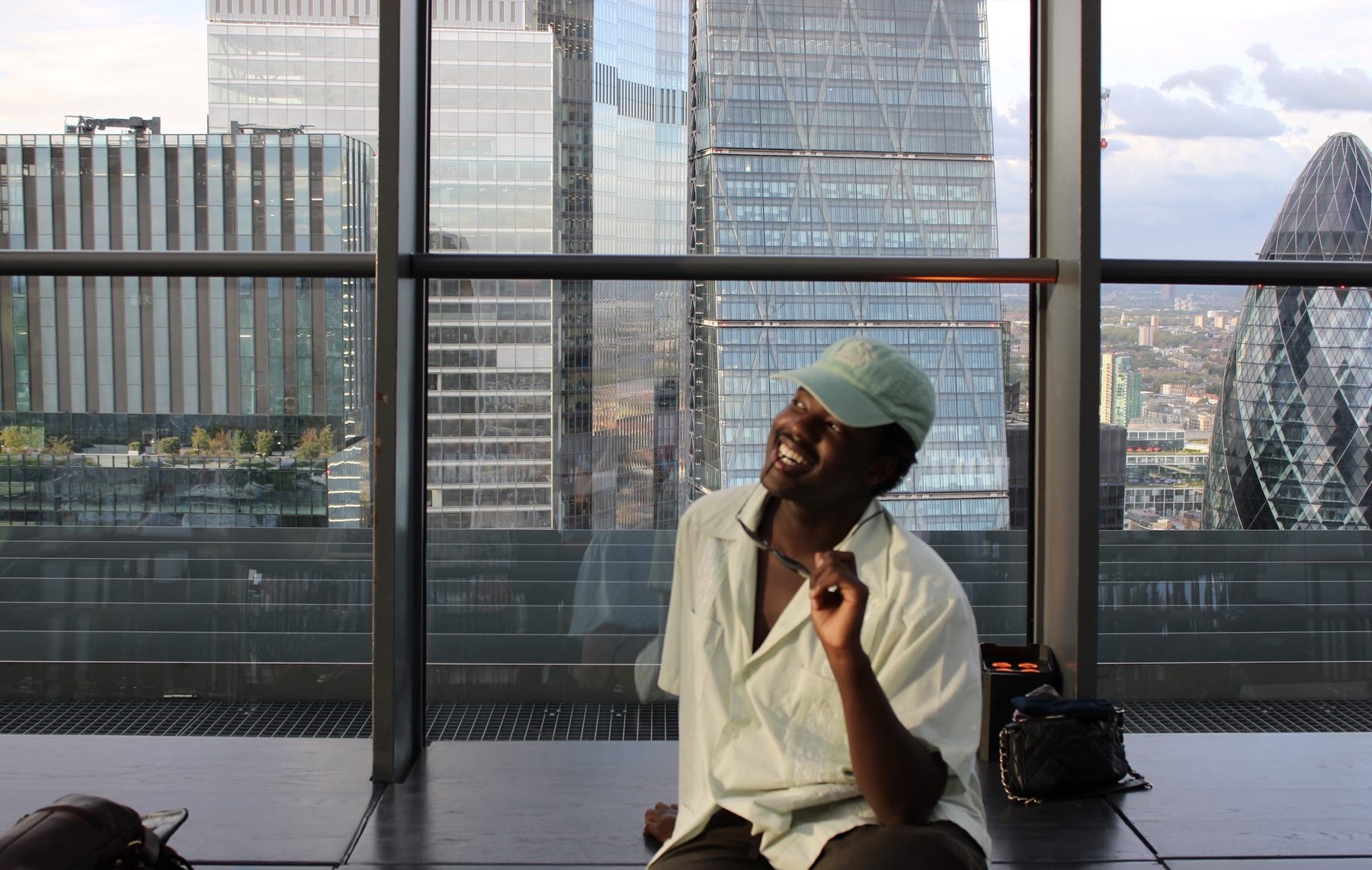 Tende laughing in front of a city view
